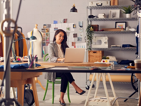 Woman running her business from a laptop in a home office